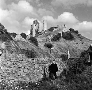 Corfe Castle Dorset rises behind a drystone wall. Corfe Castle' Corfe Castle Dorset rises behind a drystone wall. Corfe Castle'