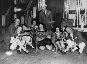 The Crazy Gang members with showgirls from the London Palladium with greyhound Mick The Crazy Gang members with showgirls from the London Palladium with greyhound Mick