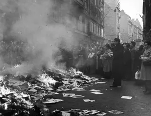 A crowd of Hungarians watch books and pamphlets from a ransacked Russian bookshop being A crowd of Hungarians watch books and pamphlets from a ransacked Russian bookshop being