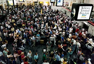 Crowd of passengers wait for their flights which are delayed July 1989 Crowd of passengers wait for their flights which are delayed July 1989