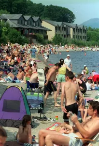 Crowds enjoying the warm weather August 1999 that has taken hold in Luss near Loch Lomond Crowds enjoying the warm weather August 1999 that has taken hold in Luss near Loch Lomond