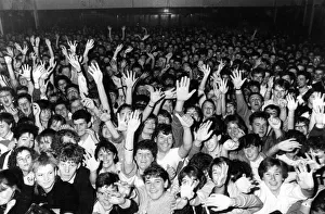 Crown of fans cheering on the Hull band Housemartins during a concert at the packed Hull Crown of fans cheering on the Hull band Housemartins during a concert at the packed Hull