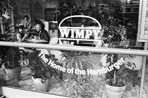 Customers enjoying a lunchtime burger at at Wimpy restaurant in London' Customers enjoying a lunchtime burger at at Wimpy restaurant in London'