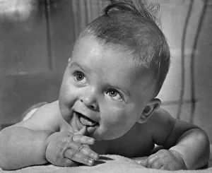 Cute baby sucking on his thumb and smiling February 1959 Cute baby sucking on his thumb and smiling February 1959