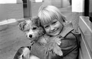 Images Dated 2nd January 1980: Cute children and Animals: Young girl holding her puppy dog. January 1980 80-00007-003