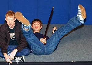 Damon Albarn lead singer of the pop group Blur lying on the floor holding a walking stick Damon Albarn lead singer of the pop group Blur lying on the floor holding a walking stick