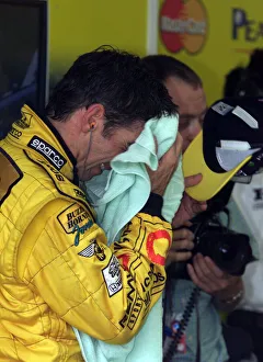 Damon Hill feels the heat after first practice session for the British Grand Prix 1999 at Damon Hill feels the heat after first practice session for the British Grand Prix 1999 at
