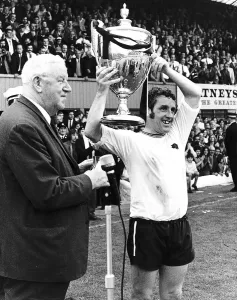 Dave Mackay of Derby holding up the Watney Cup after Derby beat Manchester United Dave Mackay of Derby holding up the Watney Cup after Derby beat Manchester United