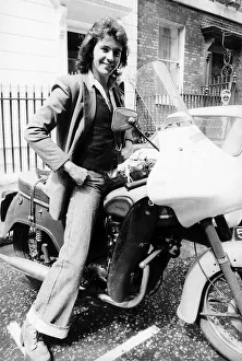 David Essex - July 1975 Singer Actor sitting on an old Triumph Motorcycle David Essex - July 1975 Singer Actor sitting on an old Triumph Motorcycle