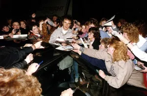 David Essex Singer Actor singing autographs as fans crowd him outside his car David Essex Singer Actor singing autographs as fans crowd him outside his car