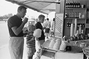 Day trippers from London enjoying candy floss, muscles and winkles from a sea food cafe Day trippers from London enjoying candy floss, muscles and winkles from a sea food cafe