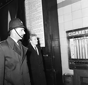 Denis Law escorted to the train at Victoria Station in Sheffield by a policeman following Denis Law escorted to the train at Victoria Station in Sheffield by a policeman following