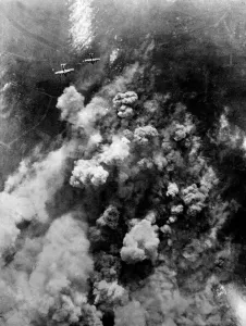Dense smoke rising from the hail of bursting bombs as Avro Lancaster bombers of RAF Dense smoke rising from the hail of bursting bombs as Avro Lancaster bombers of RAF