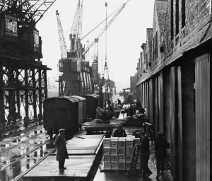 Dockers busy unloading cargo at Cardiff Docks, a port in southern Cardiff, Wales Dockers busy unloading cargo at Cardiff Docks, a port in southern Cardiff, Wales