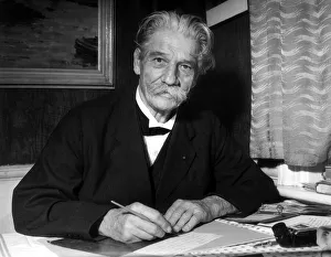 Dr. Albert Schweitzer sitting at desk writing letter October 1955 Dr. Albert Schweitzer sitting at desk writing letter October 1955