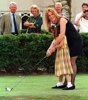 The Duchess of York teaches her daughter Princess Eugenie golf during the charity The Duchess of York teaches her daughter Princess Eugenie golf during the charity