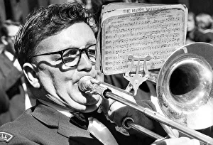 Durham Miners Gala - A big blow for this bandsman as he marches with his colleagues Durham Miners Gala - A big blow for this bandsman as he marches with his colleagues