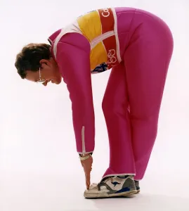 Eddie Edwards touching his toes in pink ski clothing Eddie Edwards touching his toes in pink ski clothing