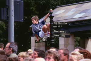 Edinburgh Festival August 1989 Boy on top of sign post Edinburgh Festival August 1989 Boy on top of sign post