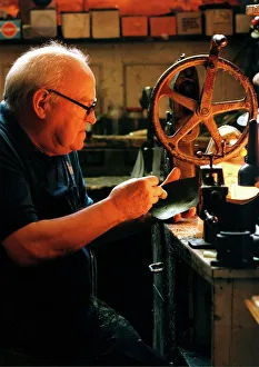 Edwin Macklow, first generation cobbler at work in his shop Edwin Macklow, first generation cobbler at work in his shop
