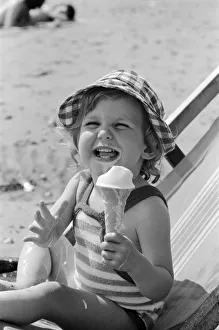 Eighteen month old Nicola England from Bromley, Kent enjoys an ice cream on the beach at Eighteen month old Nicola England from Bromley, Kent enjoys an ice cream on the beach at