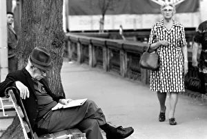 An elderly gent reading his newspaper on a park bench in Luxembourg City An elderly gent reading his newspaper on a park bench in Luxembourg City