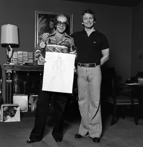 Elton John with designer Bob Mackie. 20th June 1975 Elton John with designer Bob Mackie. 20th June 1975