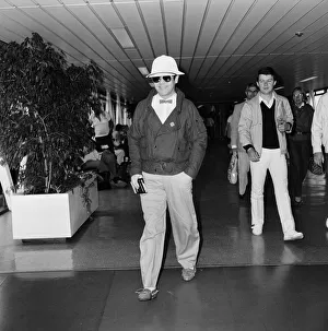 Elton John leaving Heathrow Airport for Paris to make a TV appearance. 29th June 1983 Elton John leaving Heathrow Airport for Paris to make a TV appearance. 29th June 1983
