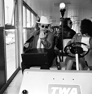 Elton John pictured at Heathrow airport. 1st June 1982 Elton John pictured at Heathrow airport. 1st June 1982
