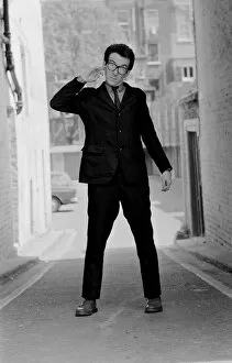 Images Dated 10th August 1977: Elvis Costello, the newest sensation on the music scene, standing in small street