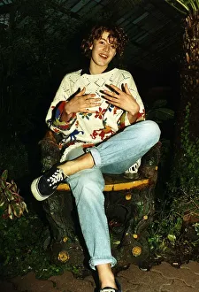 Emily Lloyd Actress sitting cross legged in wood carved chair A©Mirrorpix Emily Lloyd Actress sitting cross legged in wood carved chair A©Mirrorpix