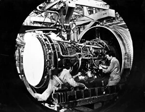 Images Dated 19th April 1984: Engineers work on a Pratt and Whitney jet engine from Boeing 747 at Nantgarw