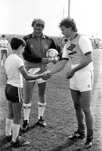 England captain Bryan Robson shakes hands with one of the boys of the local football club England captain Bryan Robson shakes hands with one of the boys of the local football club