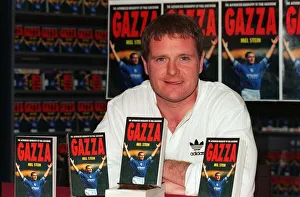 England footballer Paul Gascoigne holds up a copy of his latest autobiography at a book England footballer Paul Gascoigne holds up a copy of his latest autobiography at a book