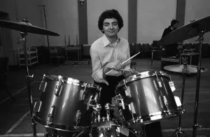 Entertainer Rowan Atkinson practices on drum kit 1980 Entertainer Rowan Atkinson practices on drum kit 1980