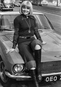 Entertainment actress Anne Aston sitting on the bonnet of her car . May 1976 P017209 Entertainment actress Anne Aston sitting on the bonnet of her car . May 1976 P017209
