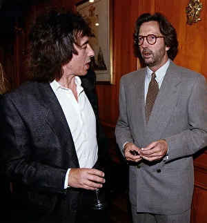 Eric Clapton at party chatting with Bill Wyman. 1995 Eric Clapton at party chatting with Bill Wyman. 1995