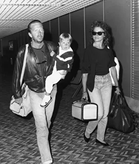 Eric Clapton singer songwriter and girlfriend Lori Del Santo walk through airport with Eric Clapton singer songwriter and girlfriend Lori Del Santo walk through airport with