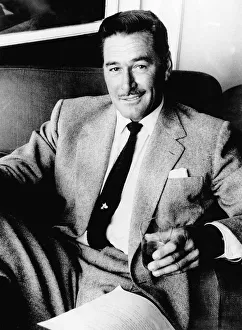 Errol Flynn Actor- September 1977 sitting in a chair with a glass in his Errol Flynn Actor- September 1977 sitting in a chair with a glass in his