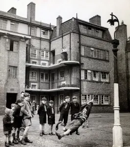 Evacuees returning from Leicestershire play in the street outside their tenement block in Evacuees returning from Leicestershire play in the street outside their tenement block in