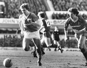 Everton footballer Kevin Sheedy on the ball chased by Mark Lawrenson during the English Everton footballer Kevin Sheedy on the ball chased by Mark Lawrenson during the English