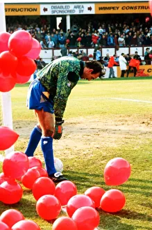 Everton goalkeeper Neville Southall catches the ball with Eric Cantona jumping Manchester Everton goalkeeper Neville Southall catches the ball with Eric Cantona jumping Manchester