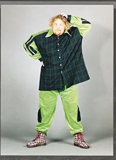 Ewan MacLeod in green and tartan suit scratching his head Ewan MacLeod in green and tartan suit scratching his head