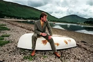 Images Dated 26th July 1998: Ewan McGregor on the Isle of Arran July 1998 with bottle of Loch Ranza single malt whisky