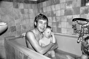 Families: Mother, father and children. Father in the bath with baby boy and son Families: Mother, father and children. Father in the bath with baby boy and son