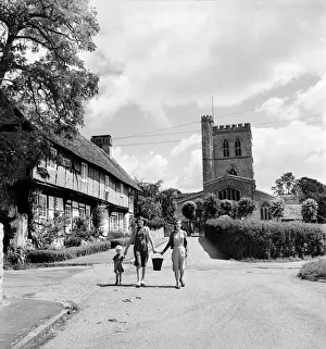 A family walk down the street in the village of Long Crendon, Buckinghamshire A family walk down the street in the village of Long Crendon, Buckinghamshire