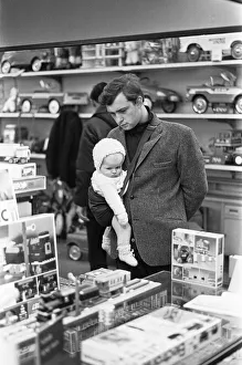 Father and baby son browse the latest Lego sets in the toy department of Heelas Father and baby son browse the latest Lego sets in the toy department of Heelas