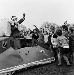 Images Dated 18th December 1970: Father Christmas arrives by hovercraft at Freegrounds Park Infant & Junior School