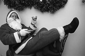 Father Christmas with a cup of tea in his grotto Birmingham. 23rd December 1988 Father Christmas with a cup of tea in his grotto Birmingham. 23rd December 1988