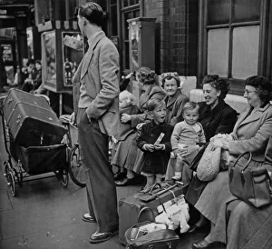 The father looks to see if the train is coming, which will take him The father looks to see if the train is coming, which will take him